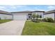 Charming single-story home featuring a well-maintained lawn and inviting front entrance at 6447 Bradford Woods Dr, Zephyrhills, FL 33542