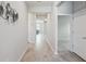 Bright hallway features elegant flooring and neutral paint at 6447 Bradford Woods Dr, Zephyrhills, FL 33542