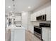 Modern kitchen featuring stainless steel appliances, granite countertops, and ample cabinetry at 6447 Bradford Woods Dr, Zephyrhills, FL 33542