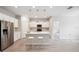 Modern kitchen features stainless steel appliances, granite countertops, and island with seating at 6447 Bradford Woods Dr, Zephyrhills, FL 33542