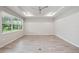 A spacious living room featuring light tile floors, a modern ceiling fan, and recessed lighting at 6447 Bradford Woods Dr, Zephyrhills, FL 33542