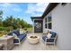 Stylish patio with modern seating around a fire pit, perfect for outdoor relaxation at 6447 Bradford Woods Dr, Zephyrhills, FL 33542
