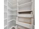 Walk-in closet with custom shelving and ample storage space at 6447 Bradford Woods Dr, Zephyrhills, FL 33542