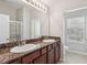 Bathroom featuring a double sink vanity with granite countertop and a large mirror at 7001 Interbay Blvd # 203, Tampa, FL 33616