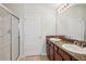 Bathroom featuring a double sink vanity with granite countertop and a glass enclosed shower at 7001 Interbay Blvd # 203, Tampa, FL 33616