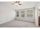Spacious bedroom with carpet, three windows, and a ceiling fan, offering a bright and airy feel at 7001 Interbay Blvd # 203, Tampa, FL 33616