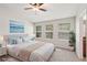 Comfortable bedroom featuring a ceiling fan, three windows, and tastefully coordinated decor at 7001 Interbay Blvd # 203, Tampa, FL 33616