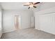 Spacious bedroom featuring neutral walls, carpeted floor, a ceiling fan, and a double door closet at 7001 Interbay Blvd # 203, Tampa, FL 33616