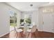 Bright dining area featuring a glass table, modern chairs, and sliding glass doors at 7001 Interbay Blvd # 203, Tampa, FL 33616