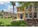 Backyard view of exterior elevation, with grass and trees on a sunny day at 7001 Interbay Blvd # 203, Tampa, FL 33616
