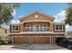 Two-story home featuring a balcony, a three-car garage, and a stone-accented facade at 7001 Interbay Blvd # 203, Tampa, FL 33616