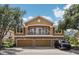 Two-story home featuring a balcony, a three-car garage, and a stone-accented facade at 7001 Interbay Blvd # 203, Tampa, FL 33616