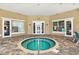 View of hot tub in a covered area with multiple chairs and windows at 7001 Interbay Blvd # 203, Tampa, FL 33616