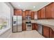 Modern kitchen with stainless steel appliances, granite countertops, and ample wooden cabinet space at 7001 Interbay Blvd # 203, Tampa, FL 33616
