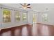 Bright living area with hardwood floors, a ceiling fan, and three large windows providing plentiful natural light at 7001 Interbay Blvd # 203, Tampa, FL 33616