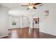 Open floorplan view showcases hardwood floors, living room windows, and an adjacent kitchen and staircase at 7001 Interbay Blvd # 203, Tampa, FL 33616