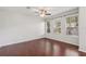 Bright main bedroom featuring hardwood floors and three large windows at 7001 Interbay Blvd # 203, Tampa, FL 33616