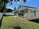 Here you see a backyard with a screened-in lanai and a privacy fence at 7301 Mitchell Ranch Rd, New Port Richey, FL 34655