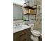 Bathroom featuring gray marble tile in shower, modern vanity, wood shelves with black iron pipes at 7301 Mitchell Ranch Rd, New Port Richey, FL 34655