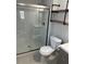 Modern bathroom with a sleek glass-enclosed shower, updated vanity, and contemporary fixtures at 7301 Mitchell Ranch Rd, New Port Richey, FL 34655
