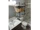 Bathroom featuring gray marble tile in shower, modern vanity, wood shelves with black iron pipes at 7301 Mitchell Ranch Rd, New Port Richey, FL 34655
