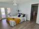 Bedroom featuring ceiling fan, luxury vinyl plank flooring and glass doors to outdoor space at 7301 Mitchell Ranch Rd, New Port Richey, FL 34655
