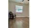 Bedroom featuring luxury vinyl plank flooring and a comfortable accent chair at 7301 Mitchell Ranch Rd, New Port Richey, FL 34655