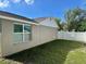 Here is the exterior of the house with a fenced in yard and a large window at 7301 Mitchell Ranch Rd, New Port Richey, FL 34655