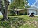 Lovely single-story home with brick accents, a well-kept lawn, and a vibrant blue front door at 7301 Mitchell Ranch Rd, New Port Richey, FL 34655