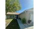 Inviting single-story home with well manicured landscaping leading to the front door at 7301 Mitchell Ranch Rd, New Port Richey, FL 34655