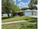 Charming single-story home features a well-manicured lawn and attached two-car garage at 7301 Mitchell Ranch Rd, New Port Richey, FL 34655