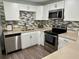Updated kitchen with stainless steel appliances, sleek countertops, and modern cabinetry at 7301 Mitchell Ranch Rd, New Port Richey, FL 34655