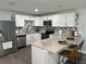 Modern kitchen features white cabinets, stainless steel appliances, and a stylish backsplash at 7301 Mitchell Ranch Rd, New Port Richey, FL 34655