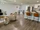 Spacious open-concept living area with a modern kitchen island and comfortable seating at 7301 Mitchell Ranch Rd, New Port Richey, FL 34655