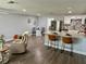 Open-concept living space with kitchen island, stainless steel appliances, and stylish dining area at 7301 Mitchell Ranch Rd, New Port Richey, FL 34655