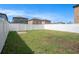 Lush backyard enclosed by a white privacy fence, showcasing the perfect outdoor space for entertaining at 7405 French Marigold Ave, Tampa, FL 33619