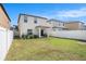 Beautiful backyard with green grass and a white fence, providing a secure and private outdoor retreat at 7405 French Marigold Ave, Tampa, FL 33619