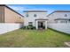 Expansive backyard with healthy green grass, enclosed by a pristine white fence for privacy and security at 7405 French Marigold Ave, Tampa, FL 33619