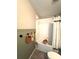 Charming bathroom featuring a tiled shower-tub, decorative accents, and stylish green wainscoting at 7405 French Marigold Ave, Tampa, FL 33619