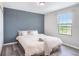 Cozy bedroom with a large window, neutral color scheme, and comfortable queen-sized bed at 7405 French Marigold Ave, Tampa, FL 33619
