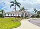 Stunning clubhouse exterior with manicured landscaping, palm trees, and a welcoming walkway at 7405 French Marigold Ave, Tampa, FL 33619