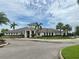 Beautiful community clubhouse featuring a neutral color palette, a covered entryway, and lush landscaping at 7405 French Marigold Ave, Tampa, FL 33619