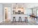 Modern kitchen featuring bar seating, stainless steel appliances, and stylish pendant lighting at 7405 French Marigold Ave, Tampa, FL 33619