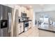 Modern kitchen features stainless steel appliances, granite countertops, and ample white cabinetry at 7405 French Marigold Ave, Tampa, FL 33619