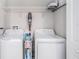 Laundry area with washer and dryer, complemented by functional shelving for storage at 7405 French Marigold Ave, Tampa, FL 33619