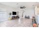 Spacious living room featuring modern tile flooring, fan, and large windows for plenty of natural light at 7405 French Marigold Ave, Tampa, FL 33619