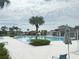 Community swimming pool with lounge chairs, a playground, and a splashpad, providing endless summer fun at 7405 French Marigold Ave, Tampa, FL 33619