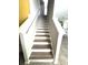 Staircase with hardwood treads and white risers leads to the upper level at 7405 French Marigold Ave, Tampa, FL 33619