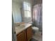 Bright bathroom featuring a vanity, toilet, and shower with decorative curtain at 7719 Carriage Pointe Dr, Gibsonton, FL 33534