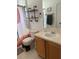 Well-lit bathroom featuring a sink, vanity, modern shower curtain, and toilet at 7719 Carriage Pointe Dr, Gibsonton, FL 33534